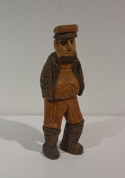 wood carving of old man by artist's grandfather